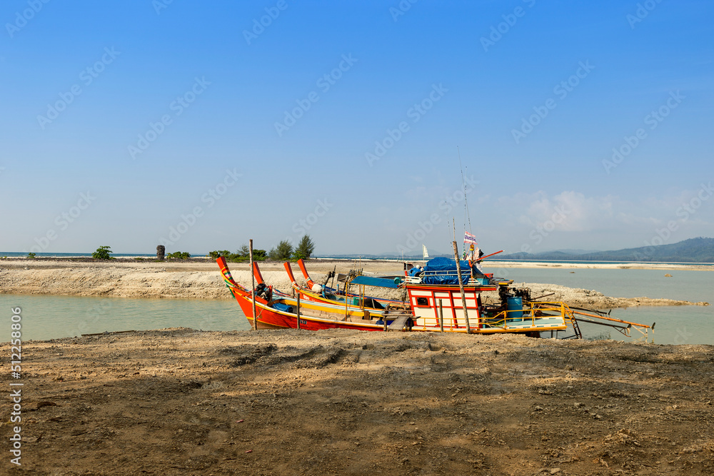 Thai style wooden fishing boats at the dead coral flats beach in Phang nga, Thailand, travel industry in south of Thailand, summer outdoor day light