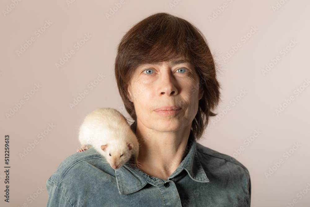 woman with a white domestic rat on her shoulder woman with a white domestic rat on her shoulder