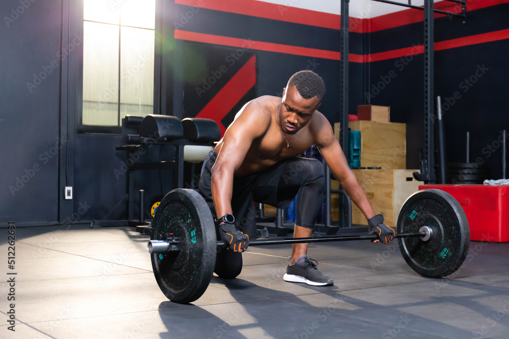 Fitness man lifting weights in gym fitness, Muscular man working out in gym doing exercises with barbell weight Fitness man lifting weights in gym fitness, Muscular man working out in gym doing exercises with barbell weight