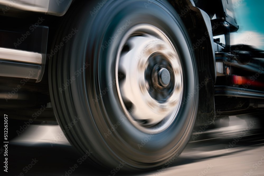 Fast Spinning Truck Wheels. Truck Speeding on the Road. Freight Truck Transportation.