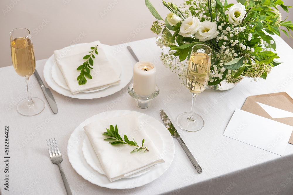 Wedding teble decoration with white flowers, glasses and white napkins. Elegantly decorated table at a wedding reception. Festive table setting. The wedding decor. Wedding teble decoration with white flowers, glasses and white napkins. Elegantly decorated table at a wedding reception. Festive table setting. The wedding decor.