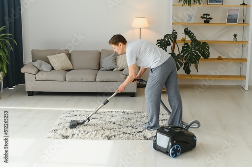 Cleaning concept. woman cleaning carpet with vacuum cleaner.