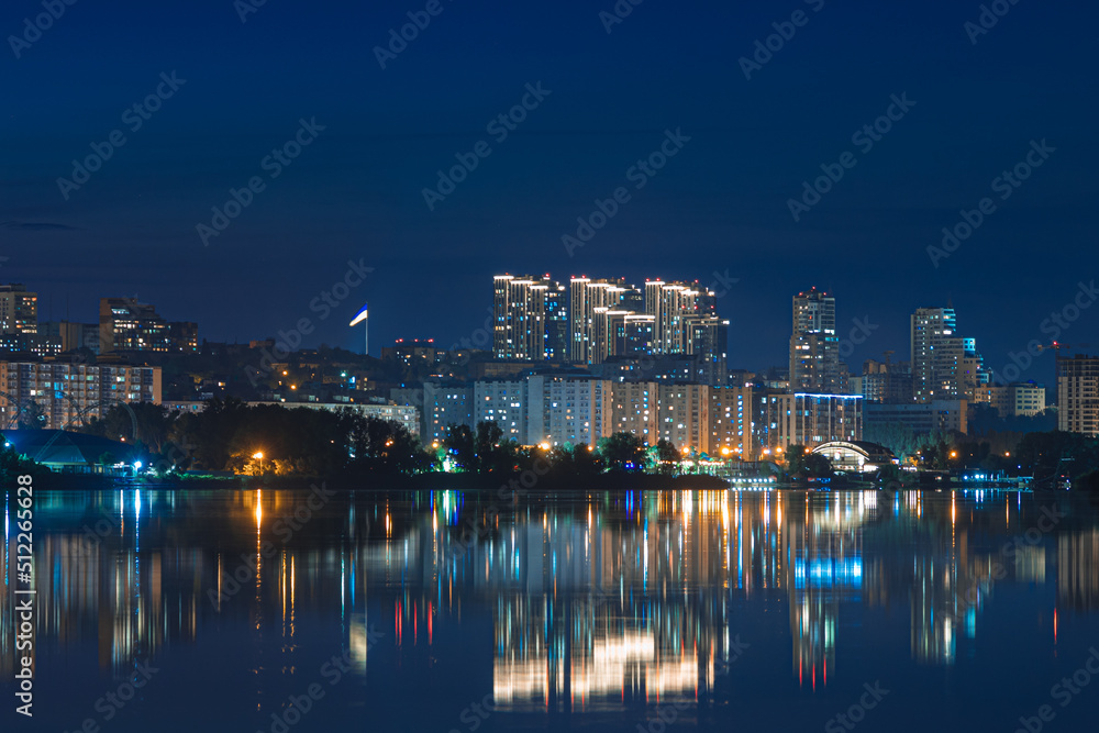 Beautiful view of the night city. Right bank of the Dnieper, lights in the night river. View of beautiful modern buildings.