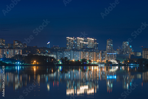 Beautiful view of the night city. Right bank of the Dnieper, lights in the night river. View of beautiful modern buildings. © Denis Chubchenko