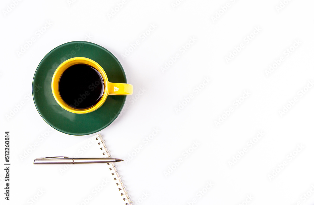 Cup of black coffee and writing instruments top view on a white background. Cup of black coffee and writing instruments top view on a white background.
