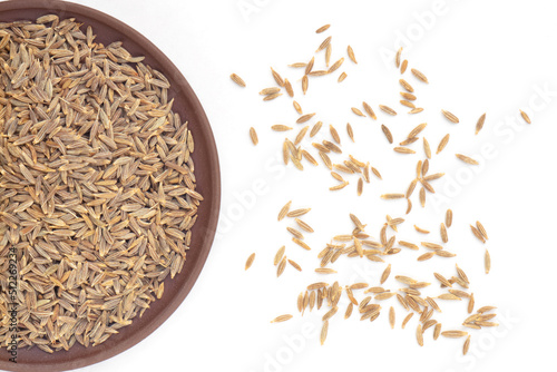 Spice cumin (jeera) in clay plate and bunch on white isolated. Vegetarian food concept