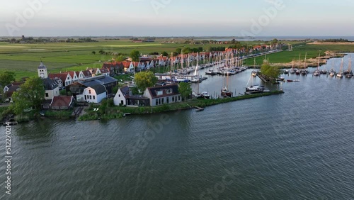 Durgerdam local dyke village with old traditional wooden houses in the north of Amsterdam. Harbour maritime countryside aerial landscape at sunset. Dutch Holland landscape. photo