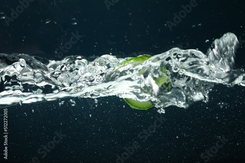 Concept of freshness, cucumber slice in clear water