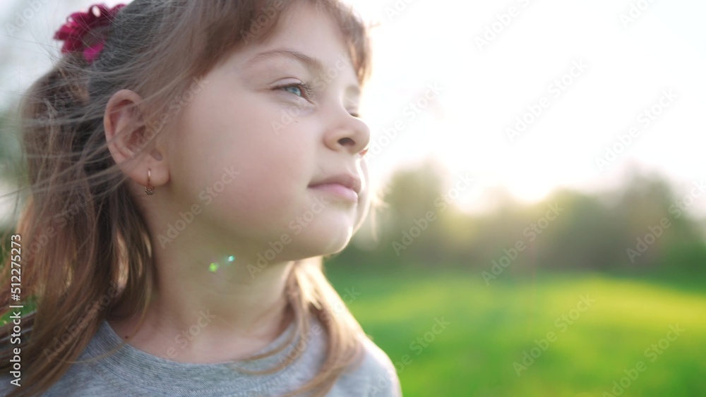 people in the park. portrait little girl outdoors. happy family kid dream concept. child girl kid portrait close-up in the park sun glare. happy cute baby in summer outdoors close up portrait sun people in the park. portrait little girl outdoors. happy family kid dream concept. child girl kid portrait close-up in the park sun glare. happy cute baby in summer outdoors close up portrait sun
