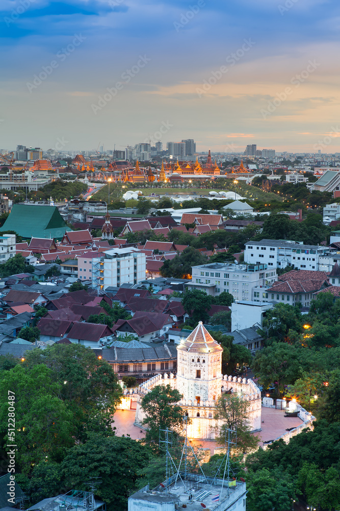 Fototapeta premium Ancient fortress tower with Grand Palace at Dusk (Bangkok, Thailand)