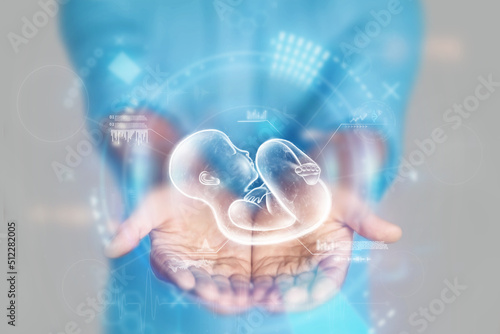 Medical concept, doctor's hands in a blue coat close-up and a hologram of a child. reproductive. Medical care, anatomy, artificial insemination. mixed media photo