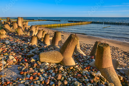 breakwater and beach in the first rays of sun, Baltic Sea in Poland