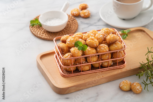 Delicious French Chouquette Choux Pastry dessert Pearl Sugar Puff on white marble background.