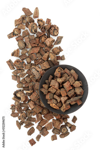 Red sage root herb used in traditional Chinese herbal plant medicine on white background. Has cardiovascular benefits and is used to treat angina. Dan shen. Salvia miltiorrhiza radix. photo