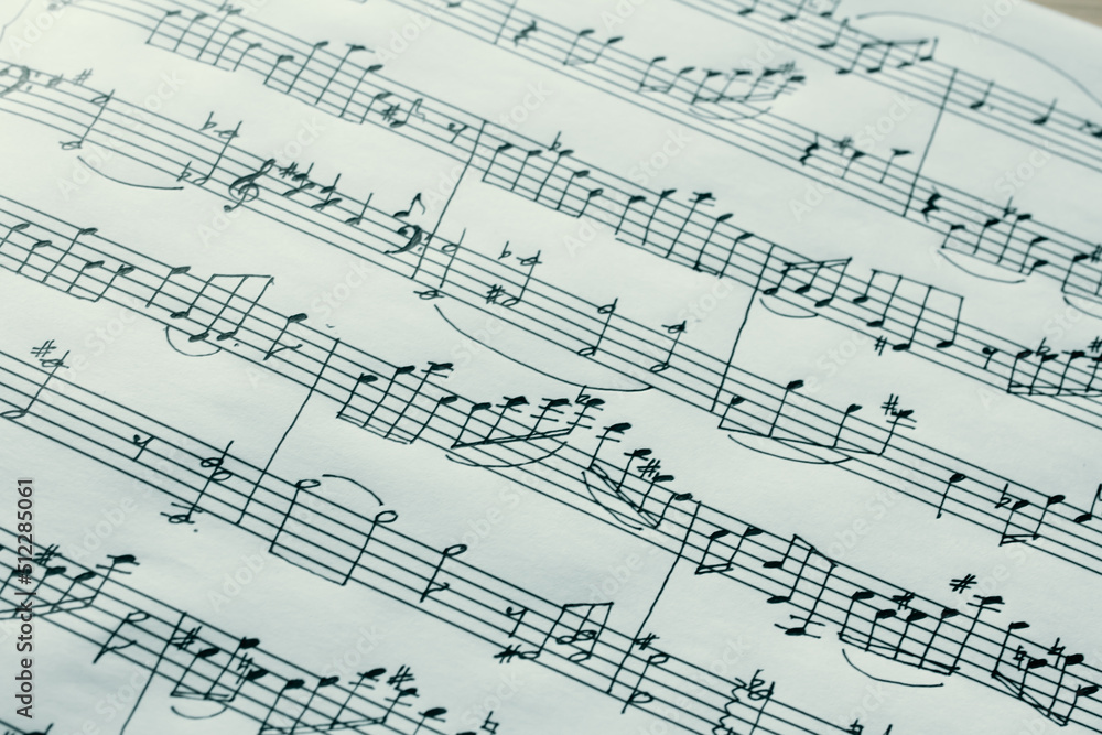 Music notes macro background, handwritten notes, selective focus Music notes macro background, handwritten notes, selective focus