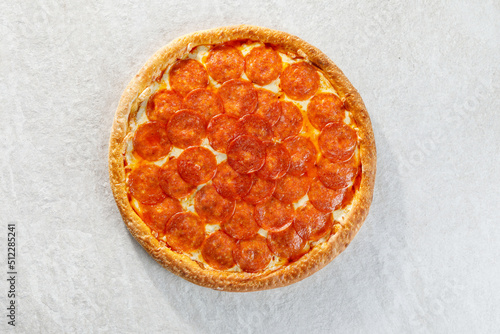 Pepperoni pizza over grey background
