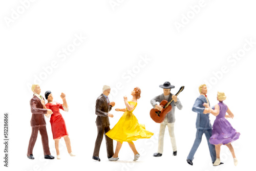 Miniature people Couple dancing with a guitarist playing the guitar on white background