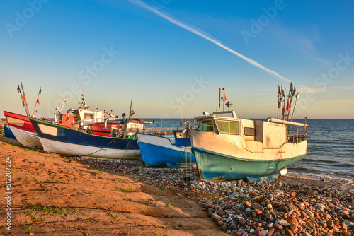 colorful fishing boats in the first rays of sun, the Baltic Sea in Poland photo