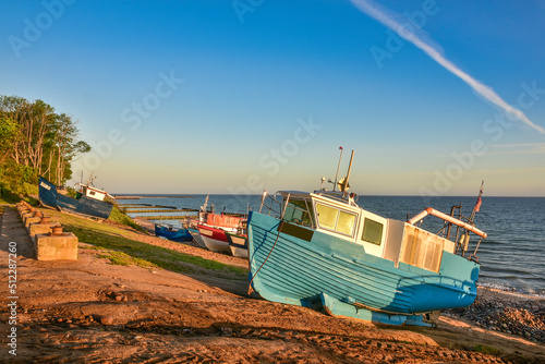 colorful fishing boats in the first rays of sun, the Baltic Sea in Poland photo