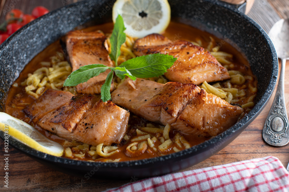 Fototapeta premium pan seared salmon fillet with cream sauce and spaetzle noodles