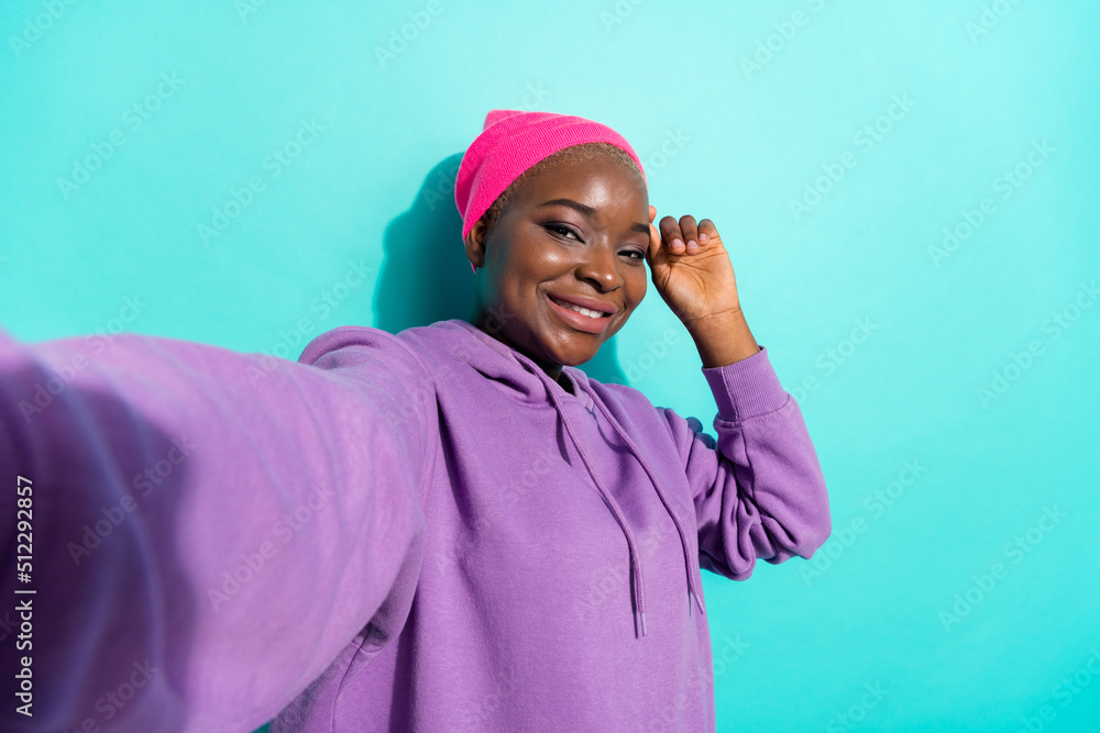 Self portrait of attractive cheerful girl wearing street style clothes look isolated over bright teal turquoise color background Self portrait of attractive cheerful girl wearing street style clothes look isolated over bright teal turquoise color background