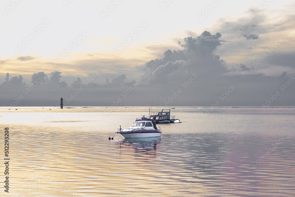 Golden hour in bay with floating boat