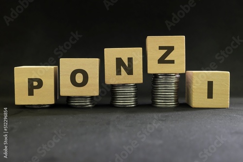 Investment scam, fraud and Ponzi scheme concept. Stack of coins on wooden blocks with word ponzi in dark black background. photo