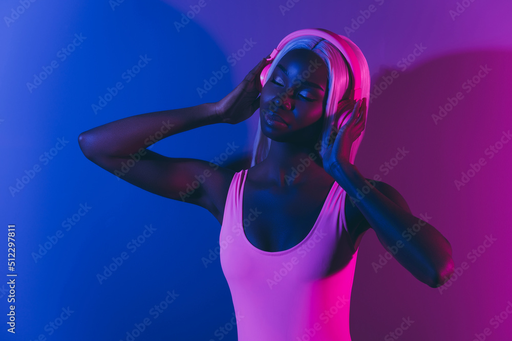 Photo of young alluring gorgeous girl dancing slow listen beat music isolated on ultraviolet bright background