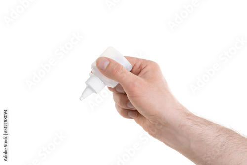 Man's hand holding a white bottle of glue trying to fix something