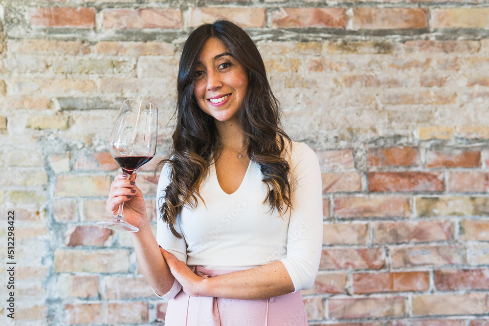 Stylish female sommelier with red wine Stylish female sommelier with red wine