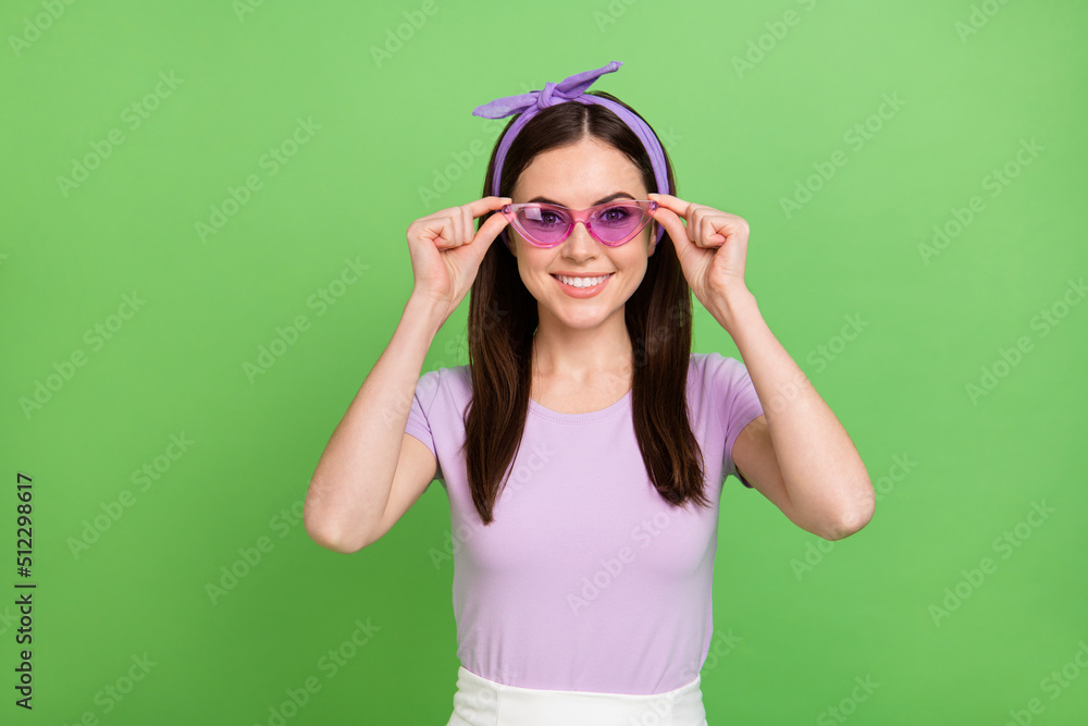 Photo of funny millennial brunette lady wear band glasses t-shirt isolated on green color background Photo of funny millennial brunette lady wear band glasses t-shirt isolated on green color background