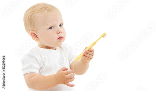 Cute baby brushes his teeth with a toothbrush. The concept of oral hygiene from the first tooth