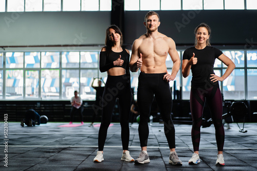 sexy caucasian man and women in gym train in fitness club with weights lifestyle wellness exercising with joy