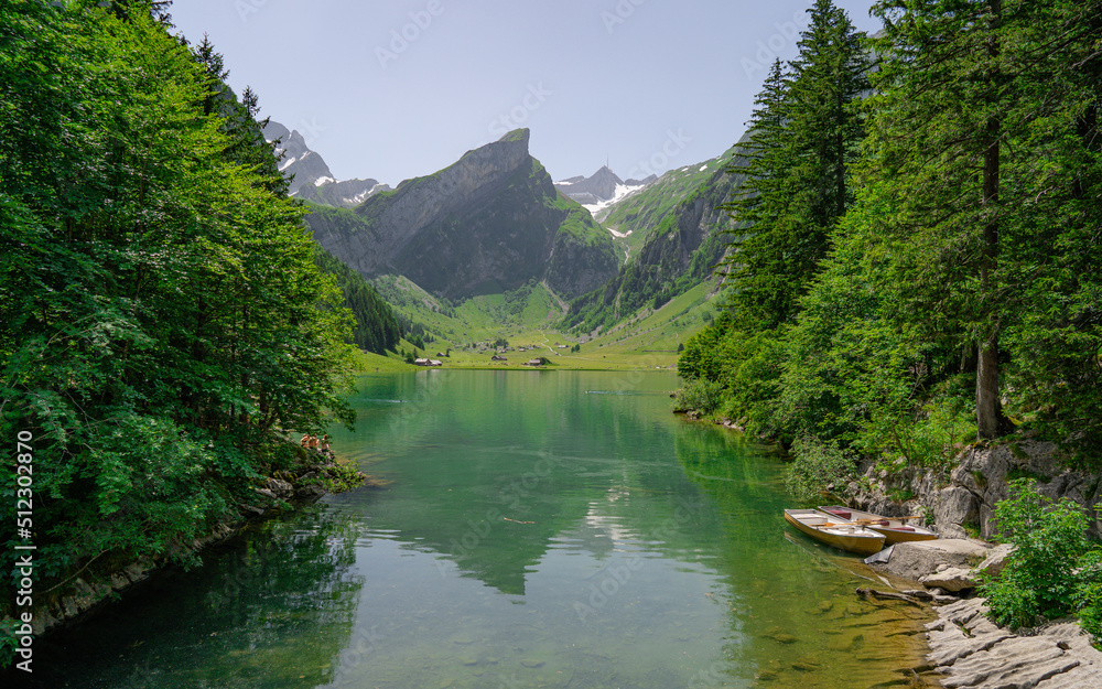 Tranquil scene of Seealpsee lake reflecting the mountain of Alpstein, Appenzell, Switzerland. Swiss mountain view. Attractive recreation region for hiking, climbing, skiing and paragliding 