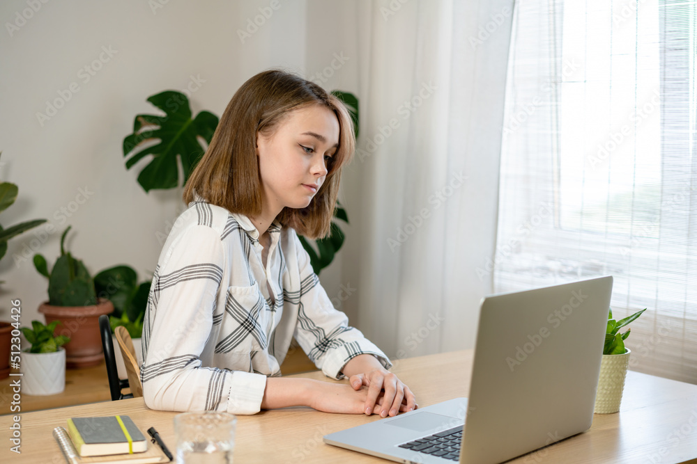 Beautiful young woman entrepreneur working on laptop at home. Female freelancer working at home office. Girl using a computer for study online at home. Remote work or study concept. Beautiful young woman entrepreneur working on laptop at home. Female freelancer working at home office. Girl using a computer for study online at home. Remote work or study concept.