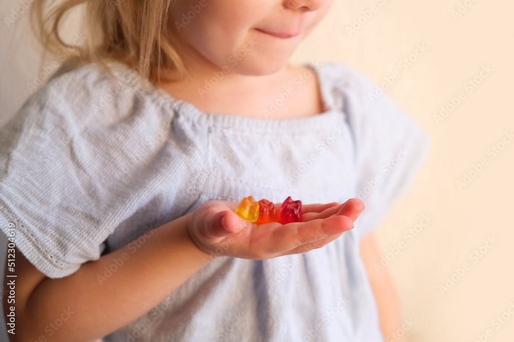 small child, blonde girl 3 years old wants to eat gelatinous sweets, gummy bear, kid has a good appetite, happy childhood, balanced diet, sweet life, unhealthy food, halal food