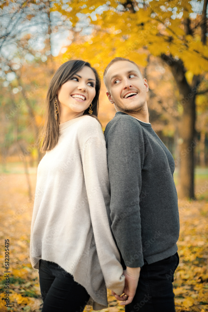A love story in an interethnic couple in nature on an autumn sunny evening A love story in an interethnic couple in nature on an autumn sunny evening