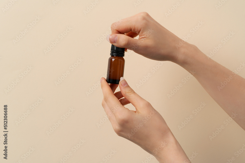 woman holding in hand a jar of liquid woman holding in hand a jar of liquid