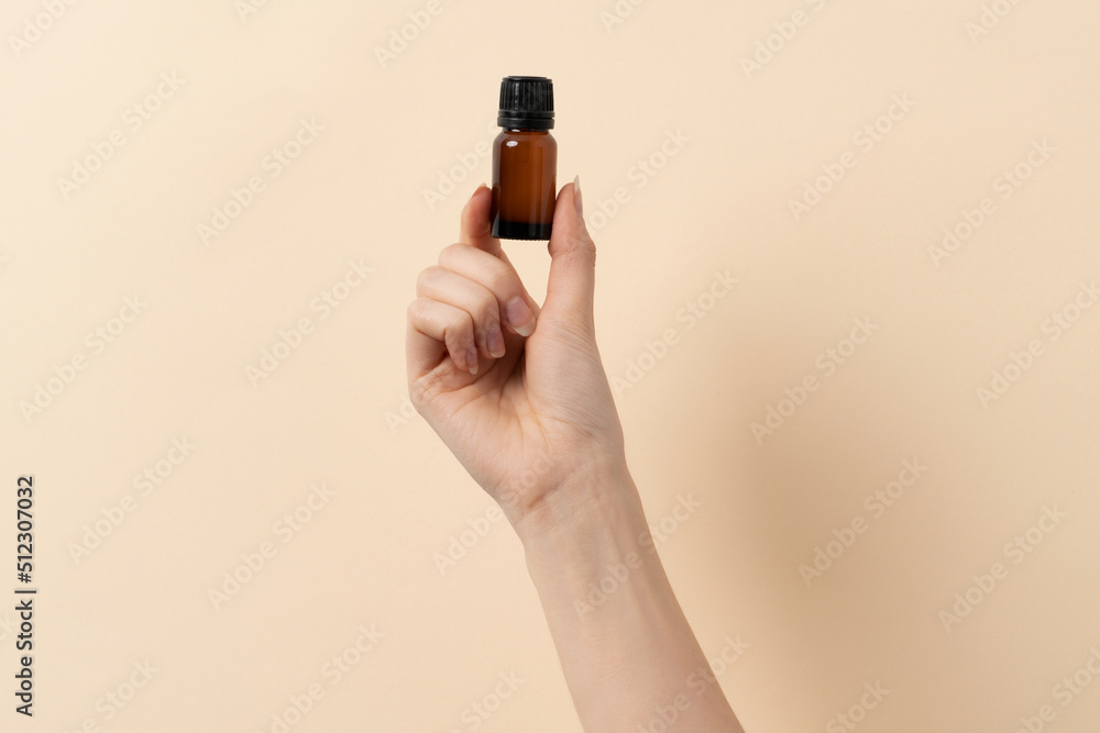 woman holding in hand a jar of liquid woman holding in hand a jar of liquid