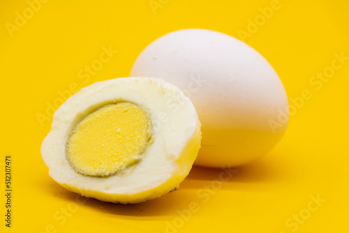 whole eggs and boil egg isolated on yellow background.