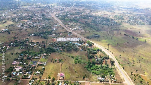 Rural settlement of kenya- Grasslands burning  accident near a town in the Eastern Africa - Aerial reverse drone shot photo