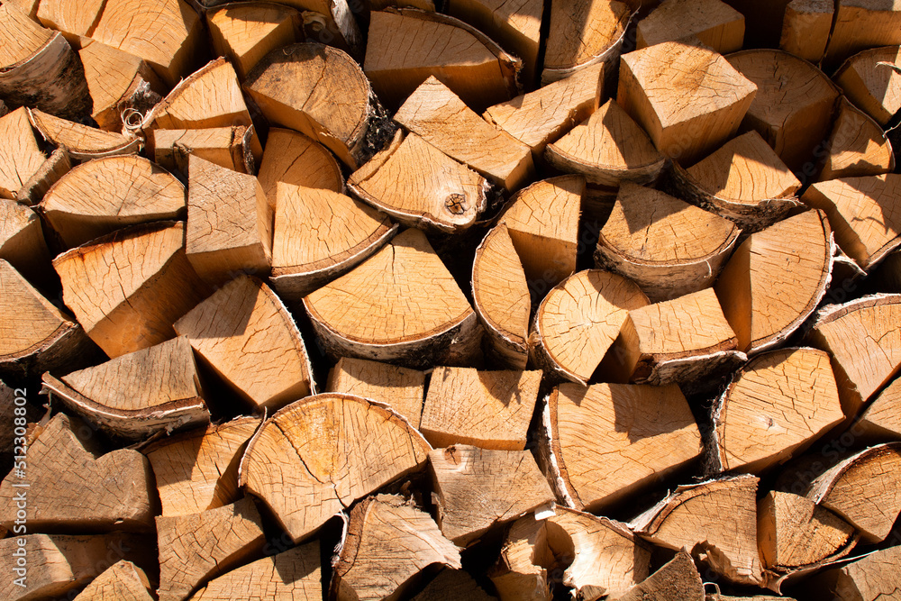Finely chopped and stacked firewood. Stacks of Firewood. Preparation of firewood for the winter. Finely chopped and stacked firewood. Stacks of Firewood. Preparation of firewood for the winter.