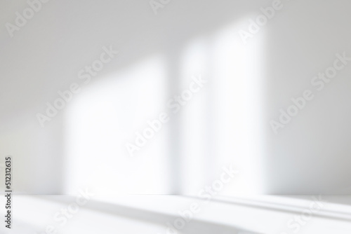 Abstract white studio background for product presentation. Empty room with shadows of window. Display product with blurred backdrop.