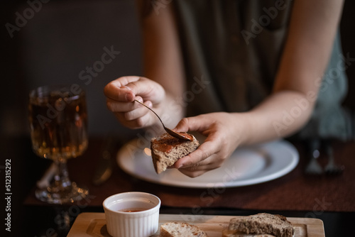 girl's hands spread on bread sauce