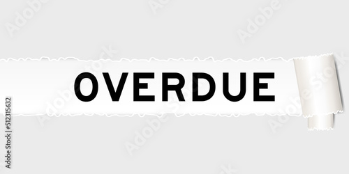 Ripped gray paper background that have word overdue under torn part