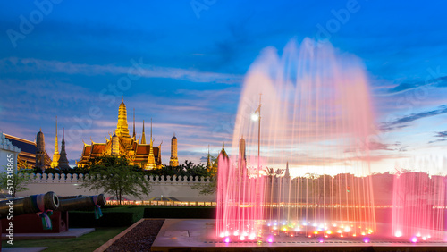 Fountain with the temple of emerald buddha at Dusk (Bangkok, Thailand)