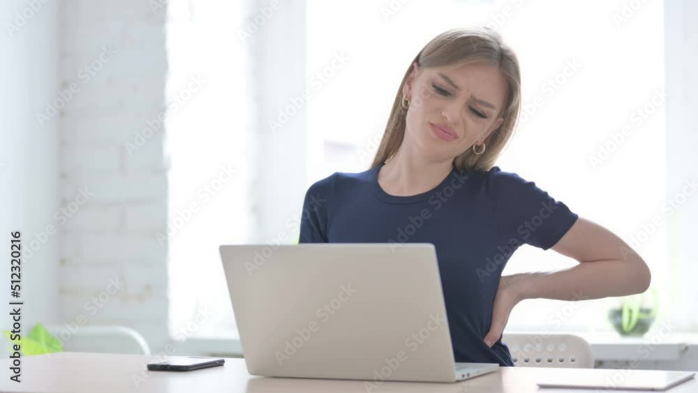 Woman having Back Pain while using Laptop Woman having Back Pain while using Laptop