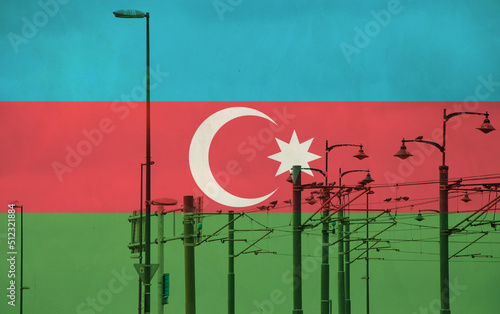 Azerbaijan flag with tram connecting on electric line with blue sky as background, electric railway train and power supply lines, cables connections and metal pole overhead catenary wire