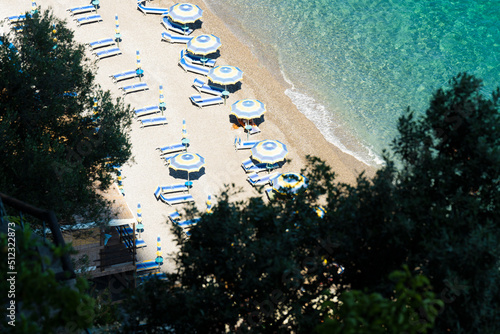 Obraz na płótnie View from above, stunning aerial view of some beach umbrellas on a beautiful beach bathed by a crystal clear water. Amalfi Coast, Italy. w salonie
