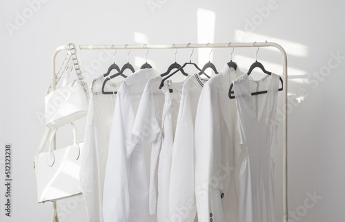 female white capsule summer wardrobe in white room